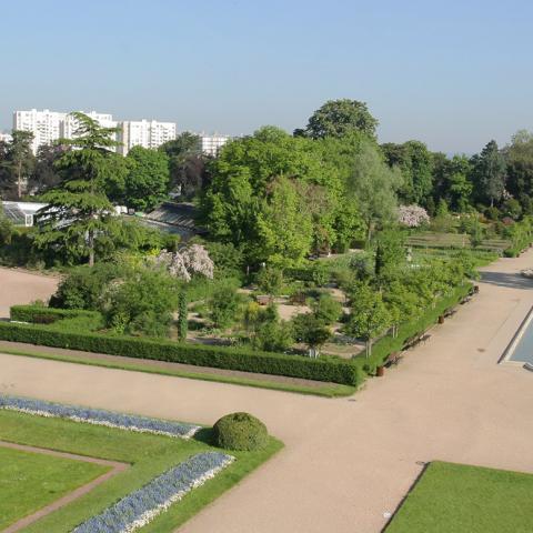 An aerial view of a garden with paths and a fountain