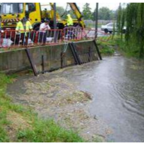 People in construction gear surveying a river from a bridge