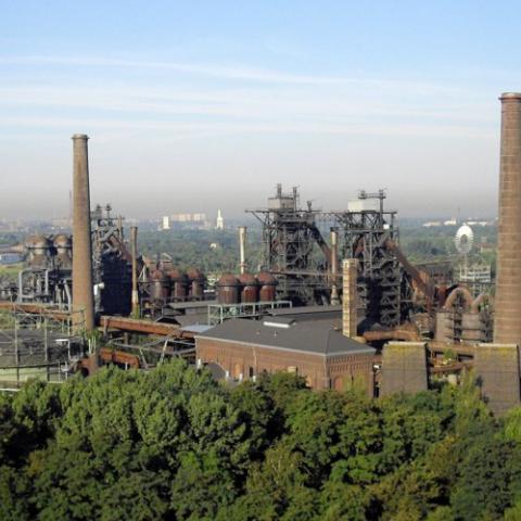 Industrial buildings surrounded by trees and greenery