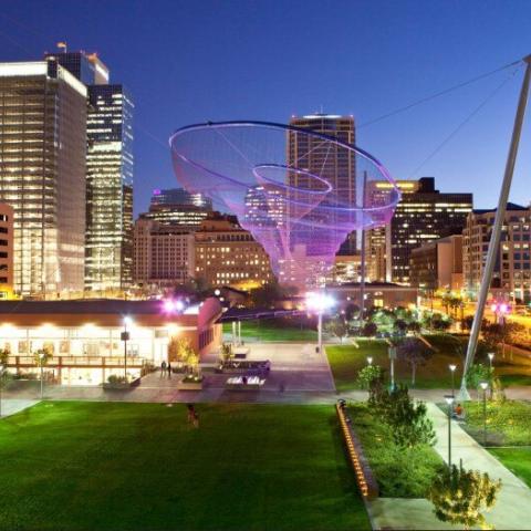 An overview of Civic Space Park at night overlooking the sculpture, “Her Secret Is Patience”