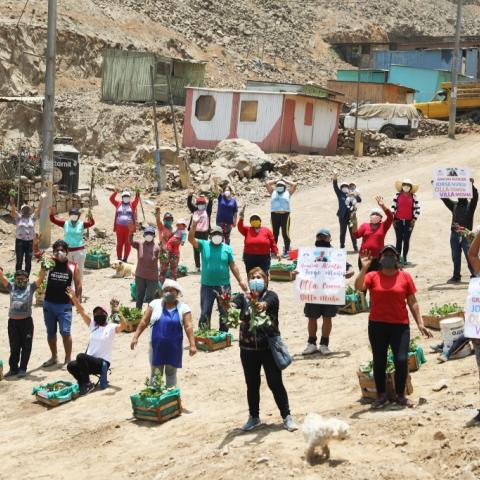 Families from Villa Mosha gathered at the community garden