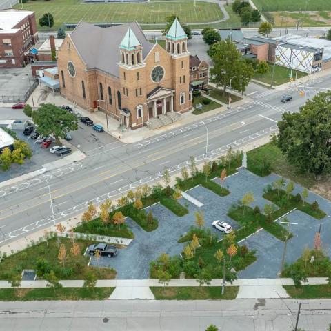 Aerial view of the green parking lot on Grand River near Warren and its surroundings.